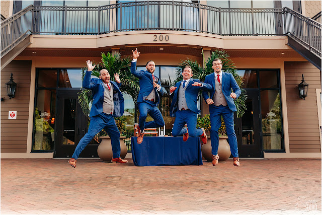 groom and groomsmen jumping