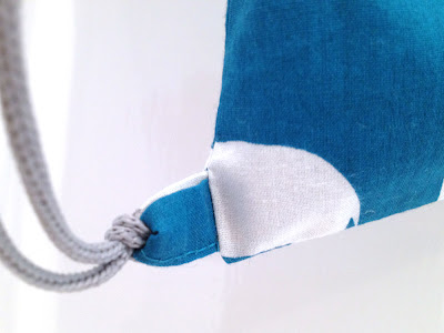 teal bag, white elephant detail : bottom corner with cord and loop