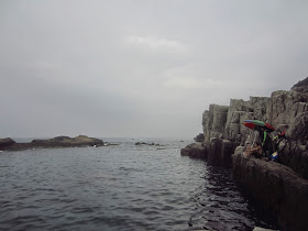 A view of the cliff faces and cove waters of Long Dong snorkeling cove. 