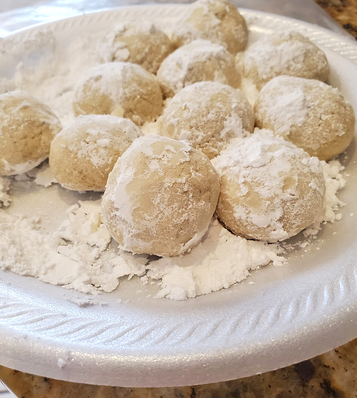 these are cookies rolled into powdered sugar in a ball shape