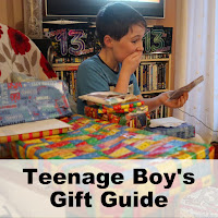 Boy looking thrilled with a pile of birthday gifts