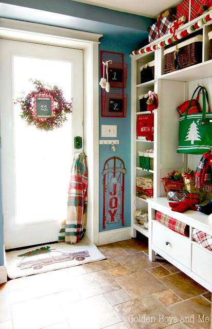 Whimsical Christmas mudroom with lots of color, plaid and presents