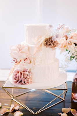 white wedding cake on geometric stand