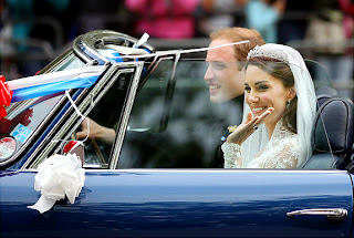 The happy couple looks picture perfect as they ride in a car after being married.