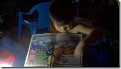 reading by lantern to Mommy (Hurricane Irene)