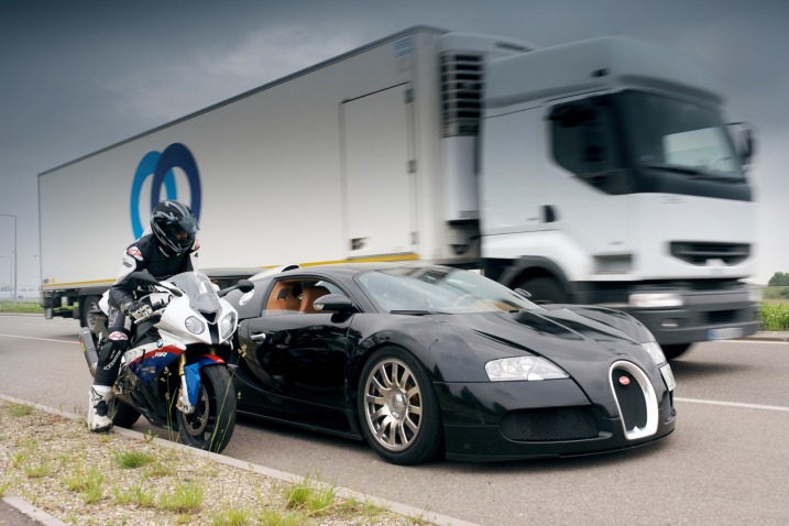 In one corner is a 2010 Bugatti Veyron while in the other sits a 2010 BMW S 