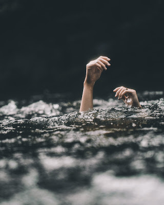 Image of two hands only above water looklike drowning: This article is about rescue stroke