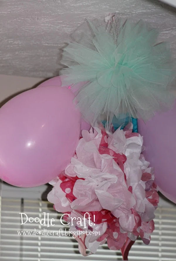 Make a pom pom out of tulle or netting for the perfect hanging decoration