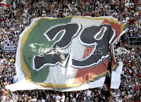 BARI, ITALY - MAY 14: Juventus supporters cheer on their team during the Serie A match between Reggina and Juventus at the Stadio Granillo on May 14, 2006 in Bari, Italy. Juventus won the match and retained their championship title. (Photo by New Press/Getty Images)