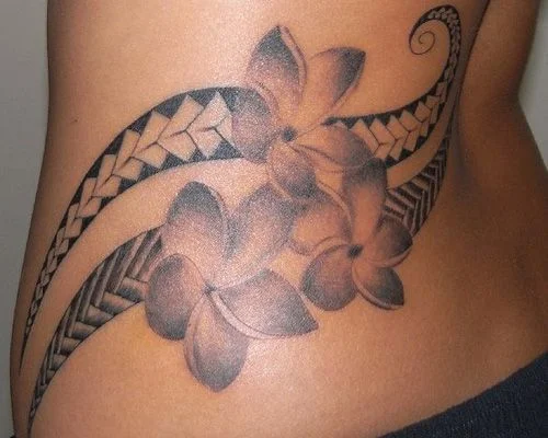 tatuaje maori con flor en la cadera de una mujer