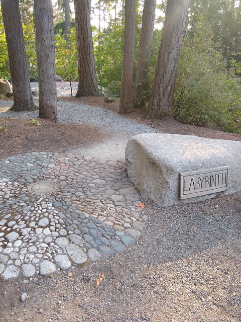 Closeup of the LABYRINTH sign and a path leading toward the labyrinth