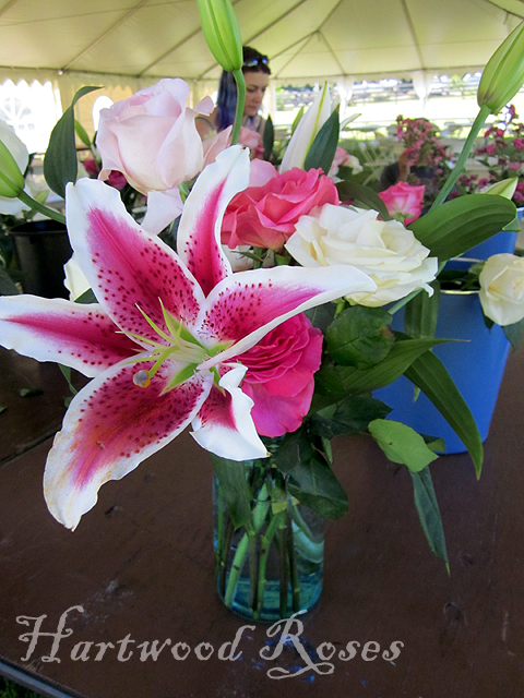 The two of them worked assemblyline style adding roses to each arrangement 