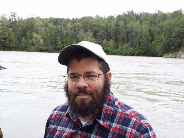 A snapshot of Brian Katcher near a body of water.