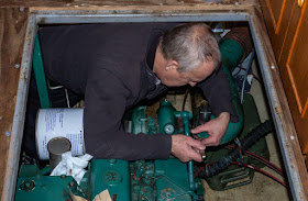 Photo of Phil tightening the bolts attaching the exhaust pipe to the turbocharger