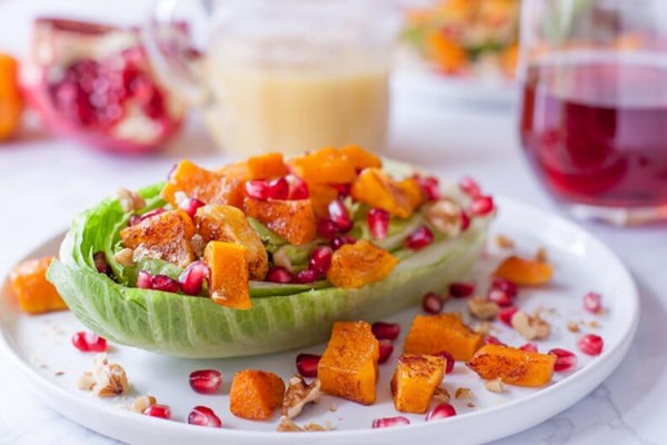 healthy superfood dinner salad with squash pomegranates