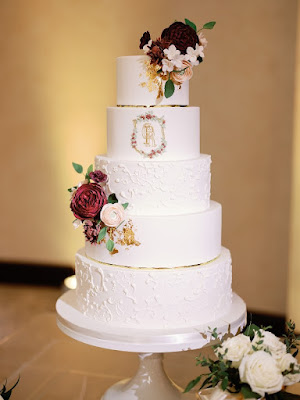 five tier white cake with burgundy floral