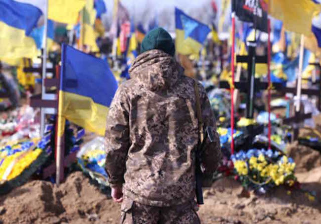 A Ukrainian soldier stands in front of the graves of Ukrainian soldiers killed in the war at a cemetery in Kharkiv. According to President Selensky, 31,000 Ukrainian soldiers have already lost their lives in the two years since the start of the Russian attack on Ukraine.