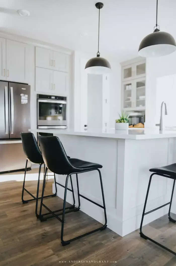 White kitchen with island and bar stools