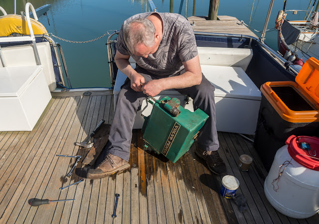 Photo of Phil working on the heat exchanger on Ravensdale's aft deck