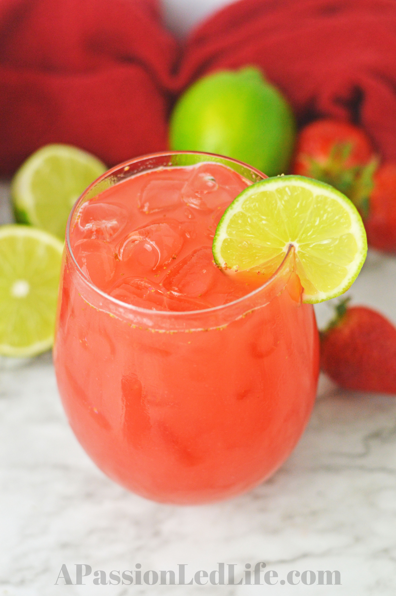 a glass of agua fresca with a lime wedge