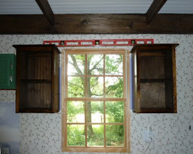 pair of Amish cabinets on either side of the kitchen window