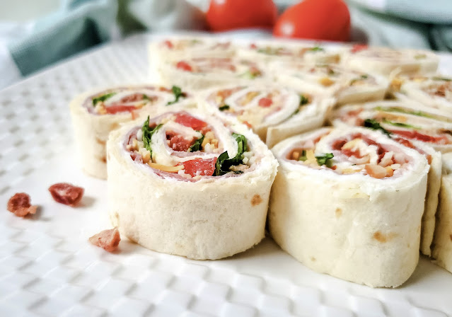 Club Sandwich Pinwheel slices on a square white plate.