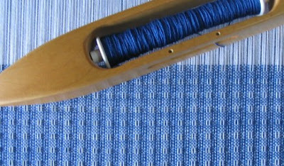 Huck towel on the loom.  8/2 cotton, white warp & royal blue weft.