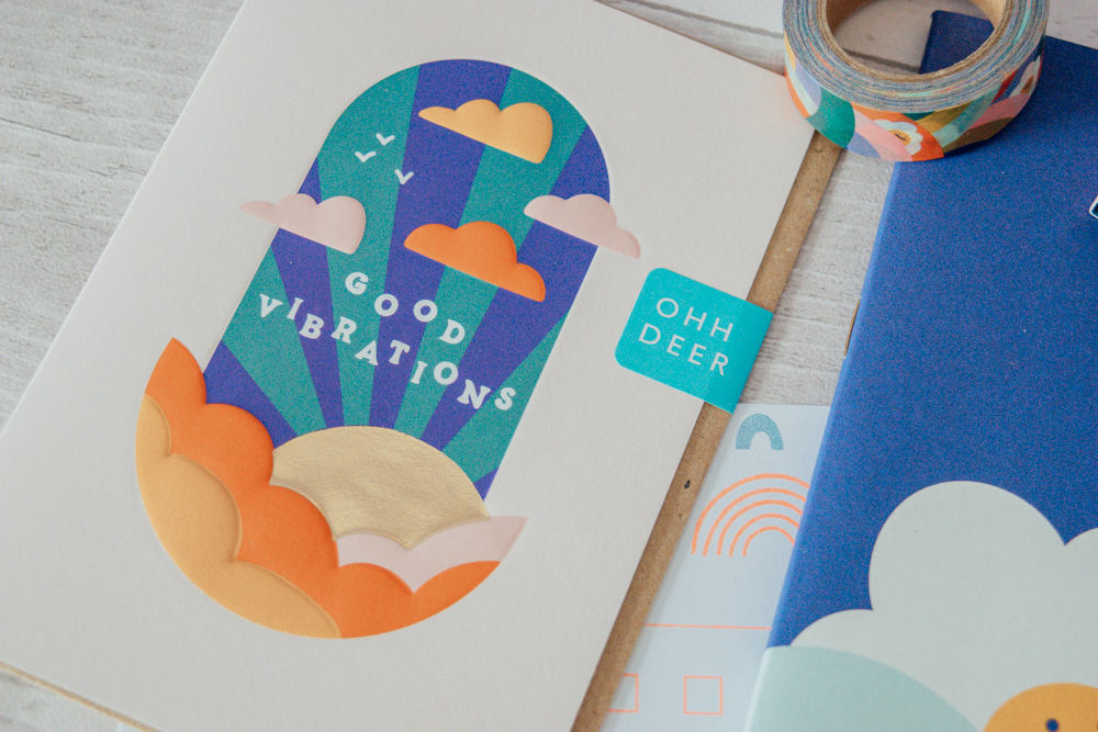 A greeting card with the quote 'good vibrations' on the front