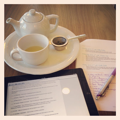 Tea on table with ipad and notes