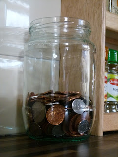 Glass jar half full of pennies