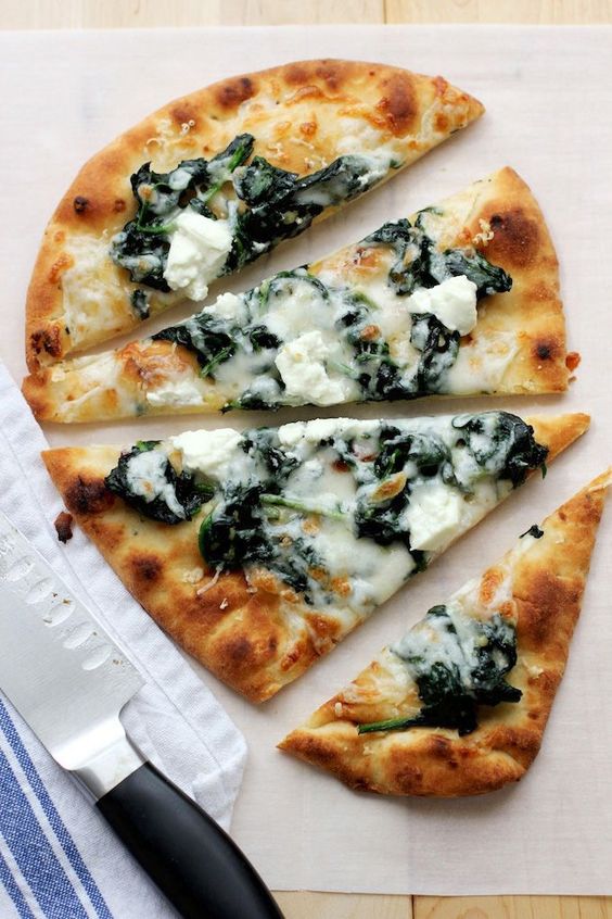 An quick, tasty flatbread pizza with garlicky spinach and tangy goat cheese. Perfect for an easy meal - just add a mixed green salad and a glass of wine and dinner is served. An quick, tasty flatbread pizza with garlicky spinach and tangy goat cheese. Perfect for an easy meal - just add a mixed green salad and a glass of wine and dinner is served.