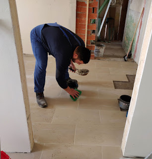 Halil cleaning as he grouts