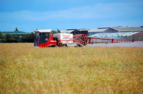 Photo of farm vehicle spraing a field of crops