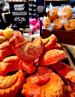 A photo of a bunch of golden hen shaped bubble bars tin a light brown square box with a black cards that says Henry penny in white font pin a bright background