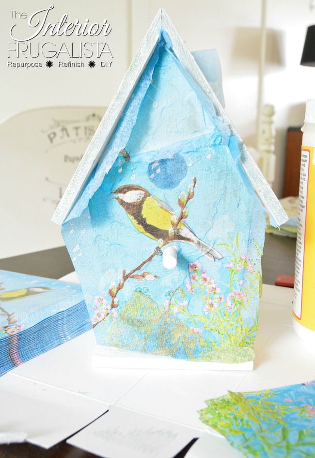 How to decoupage dollar store birdhouses with paper napkins and repurpose mini chalkboard signs for the pedestal base. Budget spring/summer decor idea.