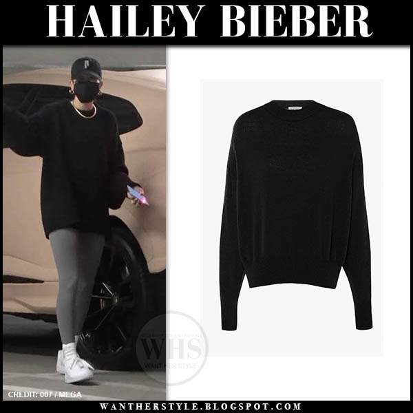 Hailey Bieber in black sweater and grey leggings