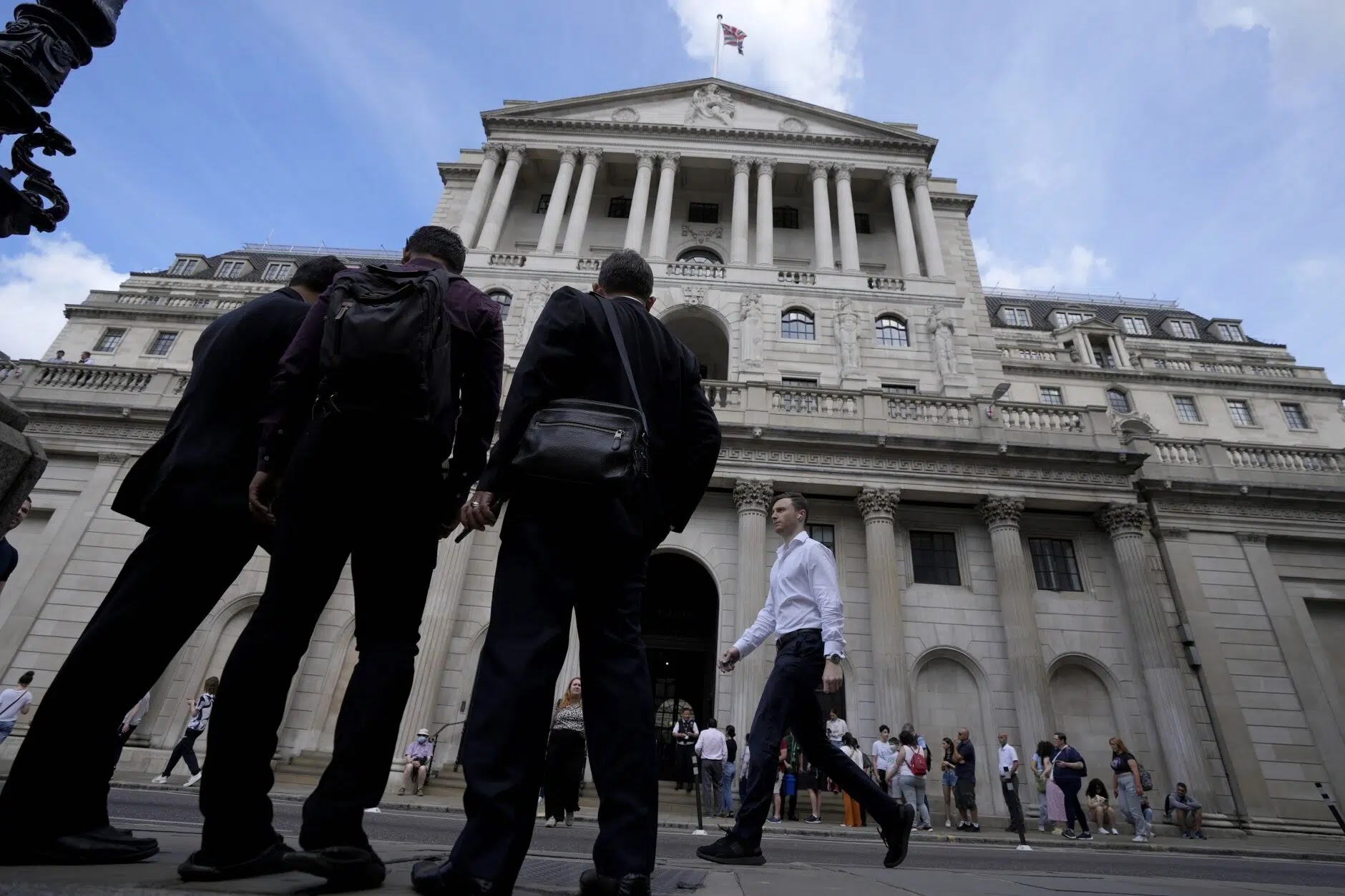 People wait at the Bank of England in London on Thursday, Aug. 4, 2022. (AP Photo/Frank Augstein)