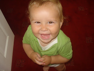 Smiling Baby Boy in a Green T-shirt