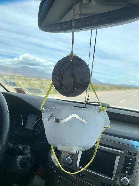 dust mask hanging from rear view mirror