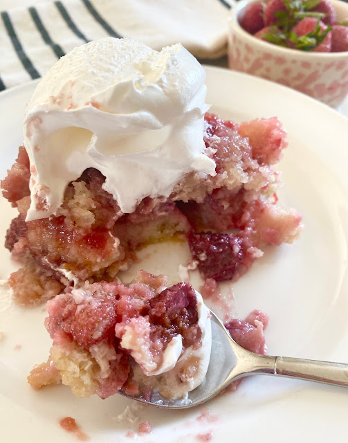 Strawberry Cake with a spoonful of a bite on a white plate.