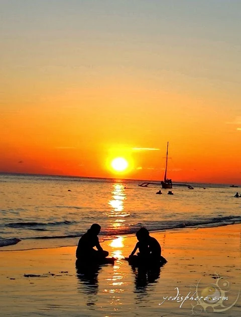 hover_share Kids playing at Boracay beach against the golden sunset.