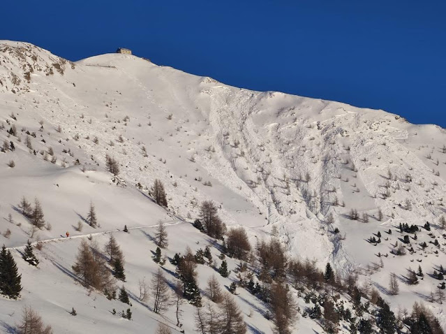 Übersichtsbild der Unfalllawine unterhalb des Helmhauses. Links oberhalb der Lawine sind die Skispuren zu erkennen. (Foto: CNSAS Sexten, 21.01.2023)