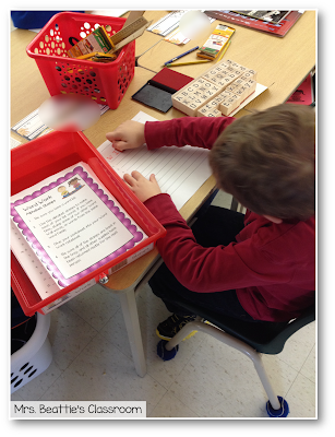 Photo of student working with alphabet stamps center.