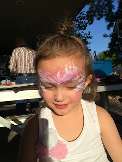 A Little Girl With A Princess Castle Painted on her face