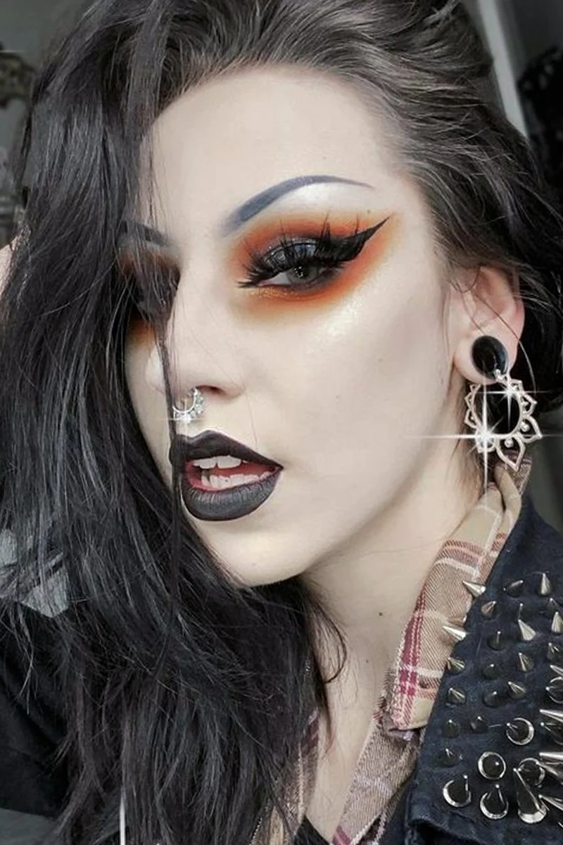 selfie of a beautiful woman with an edgy, punk makeup look and punk hairstyle