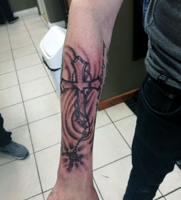 This is a beautiful religious cross tattoo with rosary tattoo designs