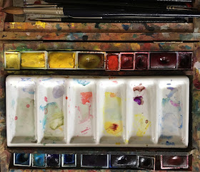 Paintbox with pans of watercolour and ceramic palette