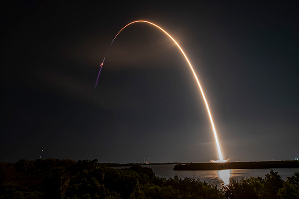 A long-exposure snapshot showing SpaceX's Falcon 9 rocket carrying the Dragon CRS-27 capsule launching from Kennedy Space Center's Pad 39A in Florida...on March 14, 2023.