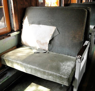 coach seat with torn seat cover