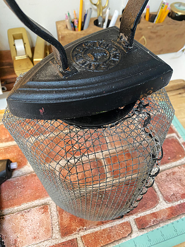 vintage iron on top of wire cloche